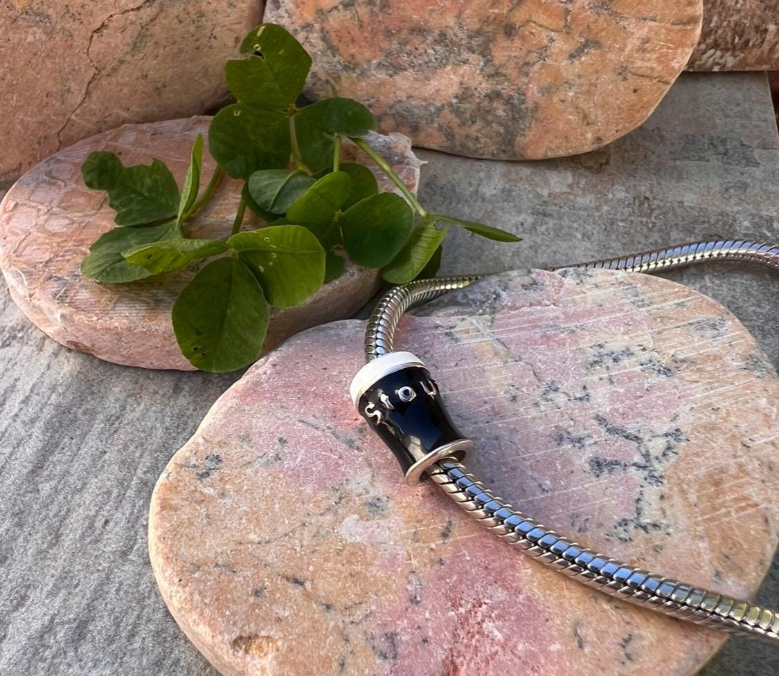 Pint of Irish stout , charm bead .