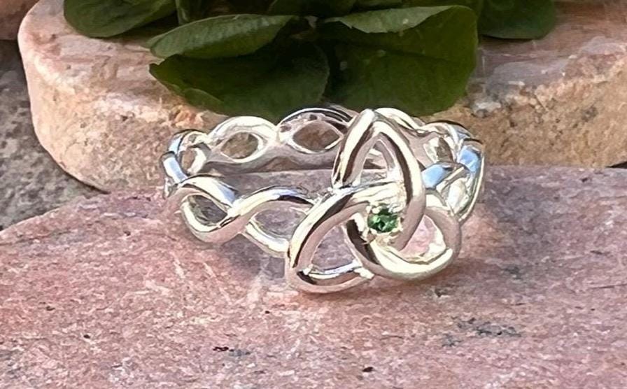 Become part of our Celtic Community with this beautiful Irish trinity know ring with its historical Braided band , an absolute Classic .
