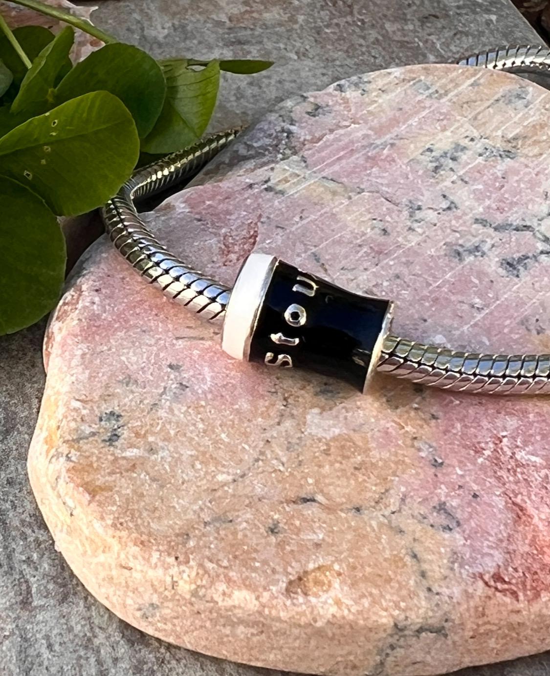 Pint  of Irish stout  , charm bead .