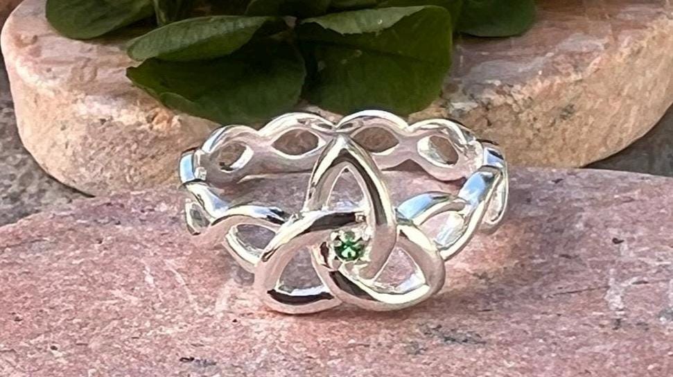Become part of our Celtic Community with this beautiful Irish trinity know ring with its historical Braided band , an absolute Classic .