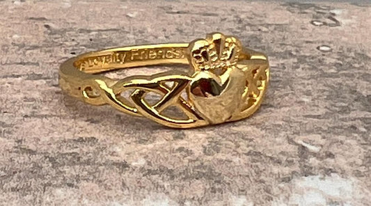 14 CT, Gold Coated Sterling Silver  Claddagh ring with two trinity’s on either side of the heart .