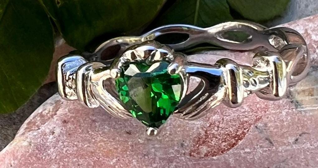 woven band ladies Silver claddagh ring with emerald green cz heart, from Galway the home of the Claddagh ring .