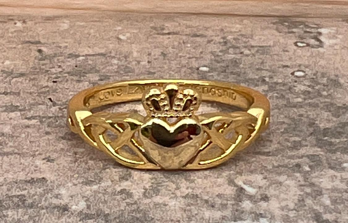 14 CT, Gold Coated Sterling Silver  Claddagh ring with two trinity’s on either side of the heart .
