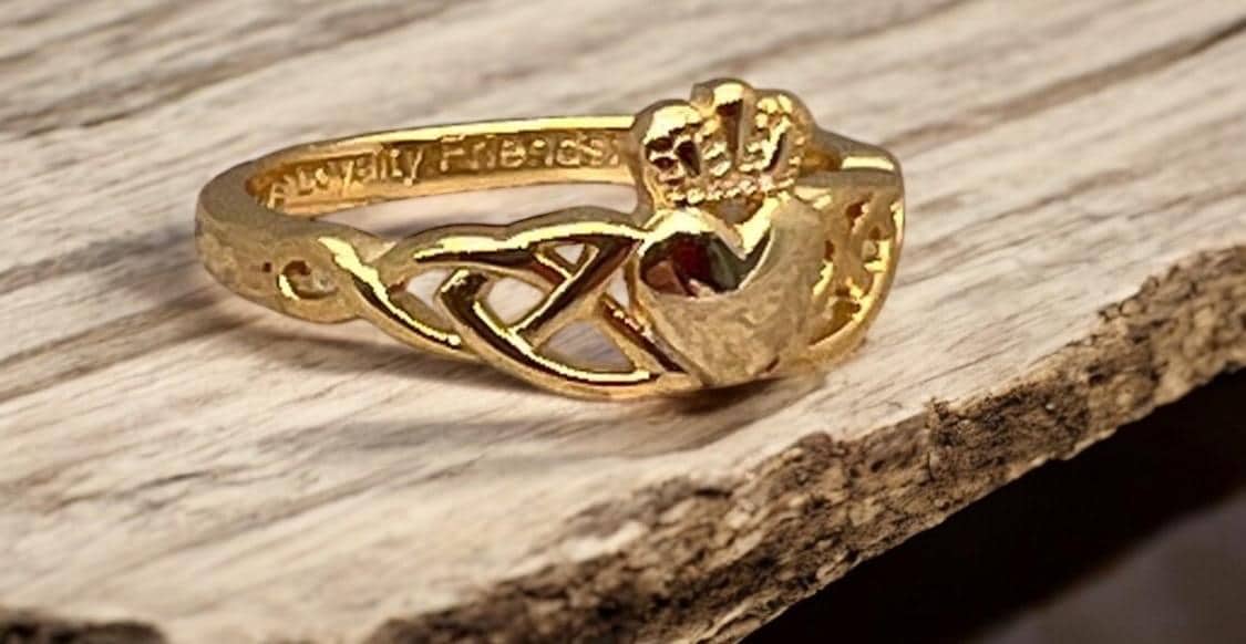14 CT, Gold Coated Sterling Silver  Claddagh ring with two trinity’s on either side of the heart .