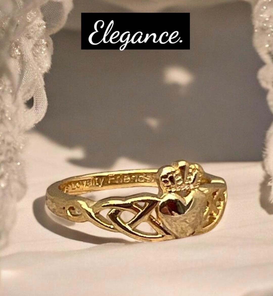 14 CT, Gold Coated Sterling Silver  Claddagh ring with two trinity’s on either side of the heart .