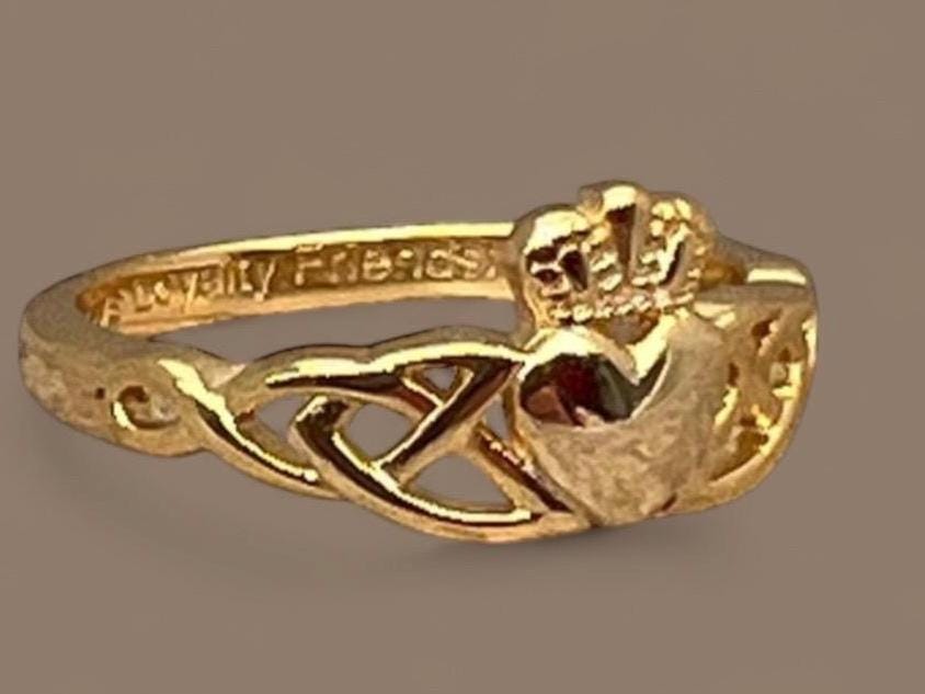 14 CT, Gold Coated Sterling Silver  Claddagh ring with two trinity’s on either side of the heart .