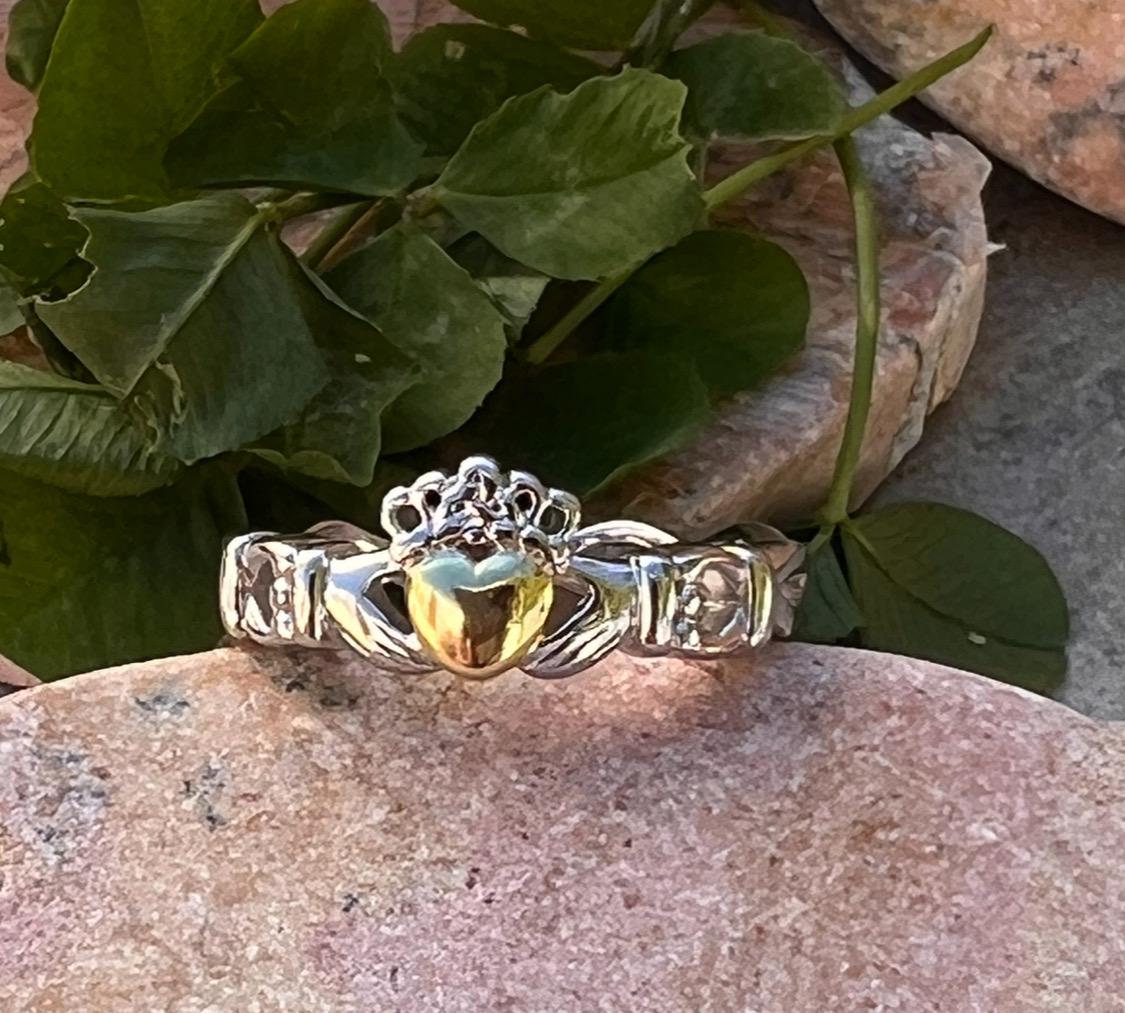 ladies solid claddagh ring with a 14 ct plated heart .