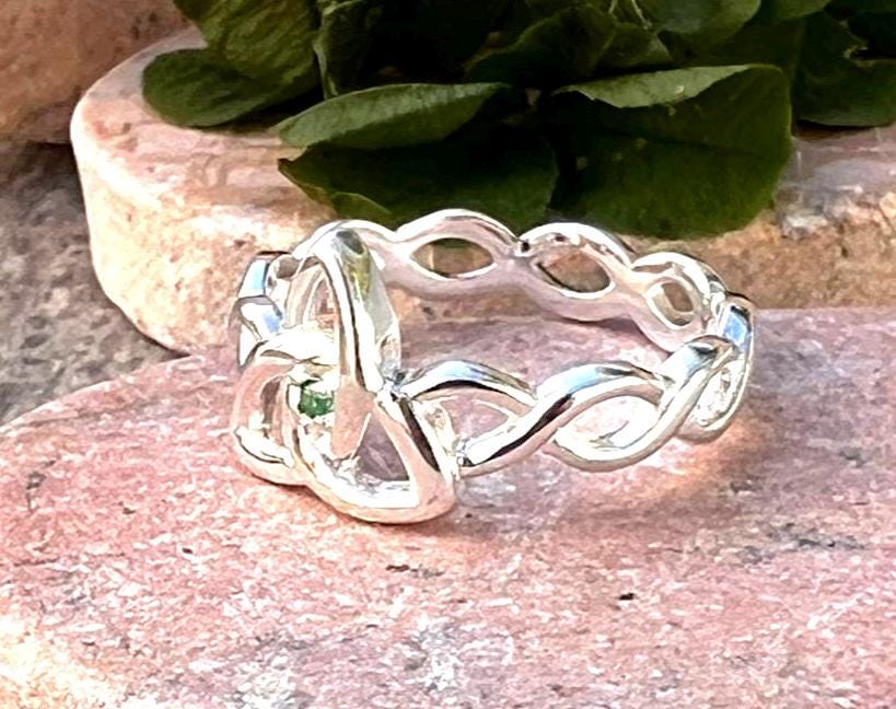 Become part of our Celtic Community with this beautiful Irish trinity know ring with its historical Braided band , an absolute Classic .