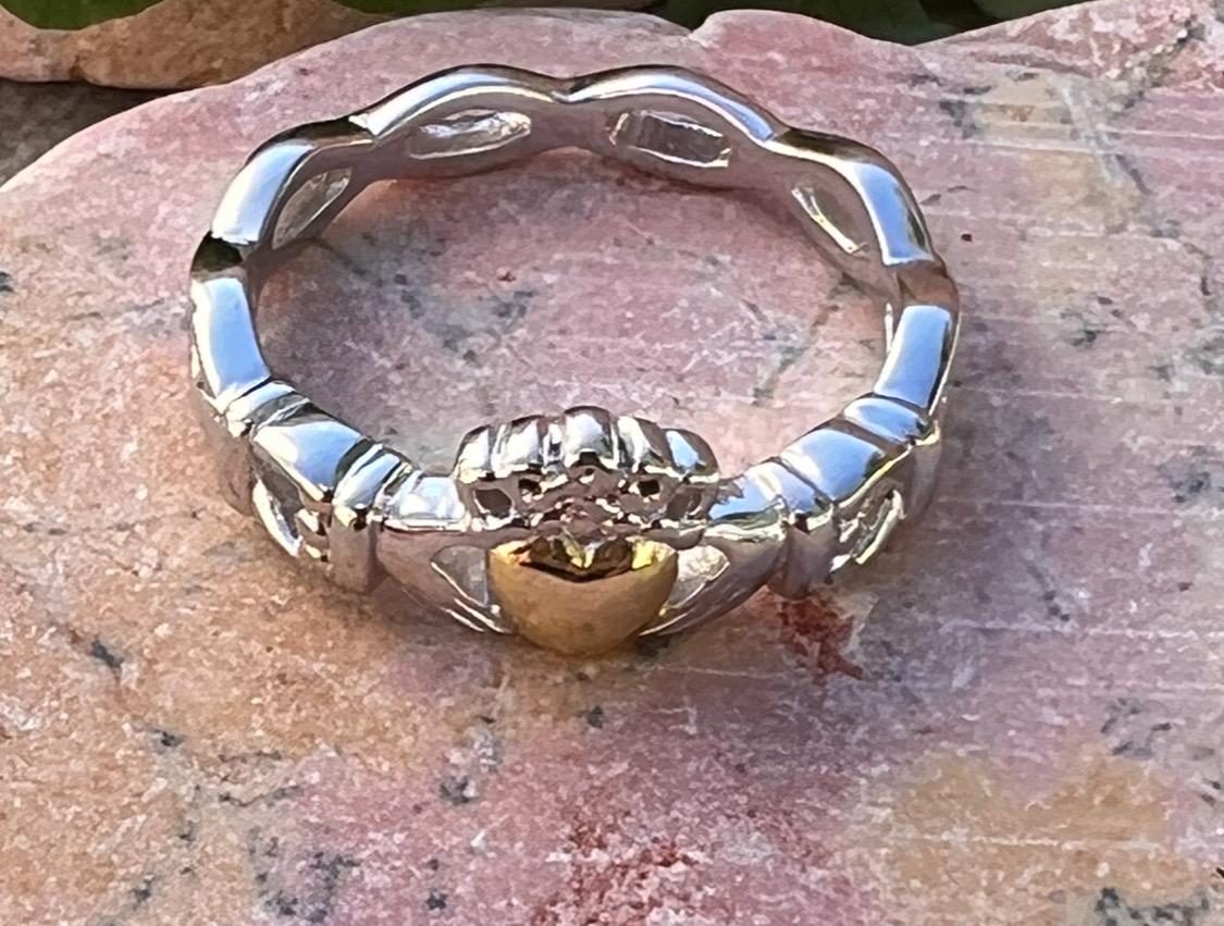 ladies solid claddagh ring with a 14 ct plated heart .