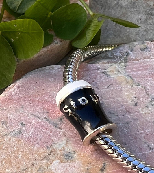 Pint  of Irish stout  , charm bead .