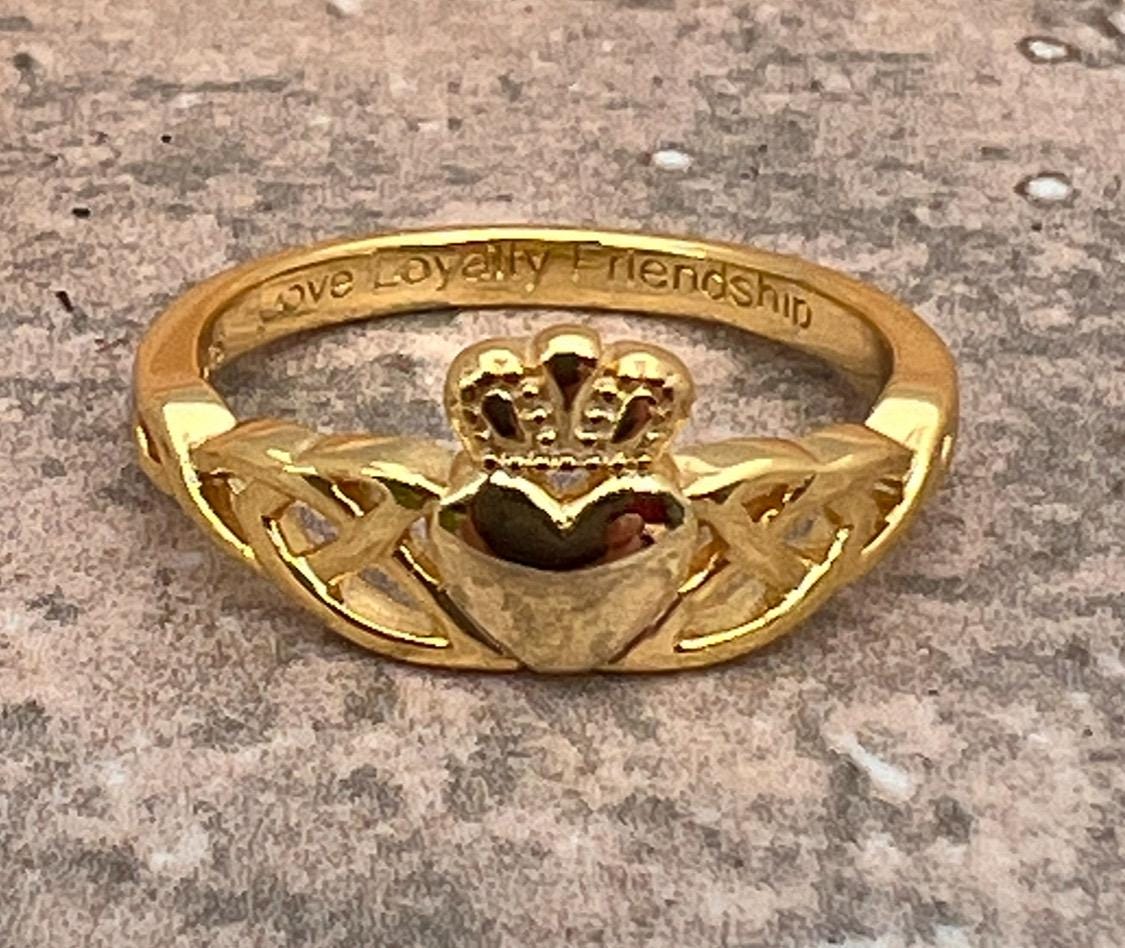 14 CT, Gold Coated Sterling Silver  Claddagh ring with two trinity’s on either side of the heart .