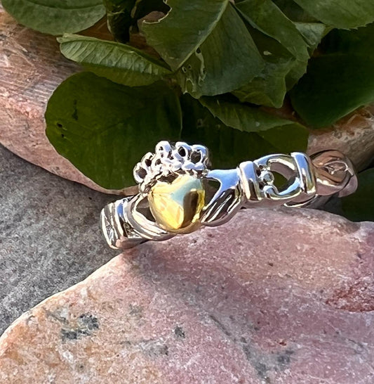 ladies solid claddagh ring with a 14 ct plated heart .