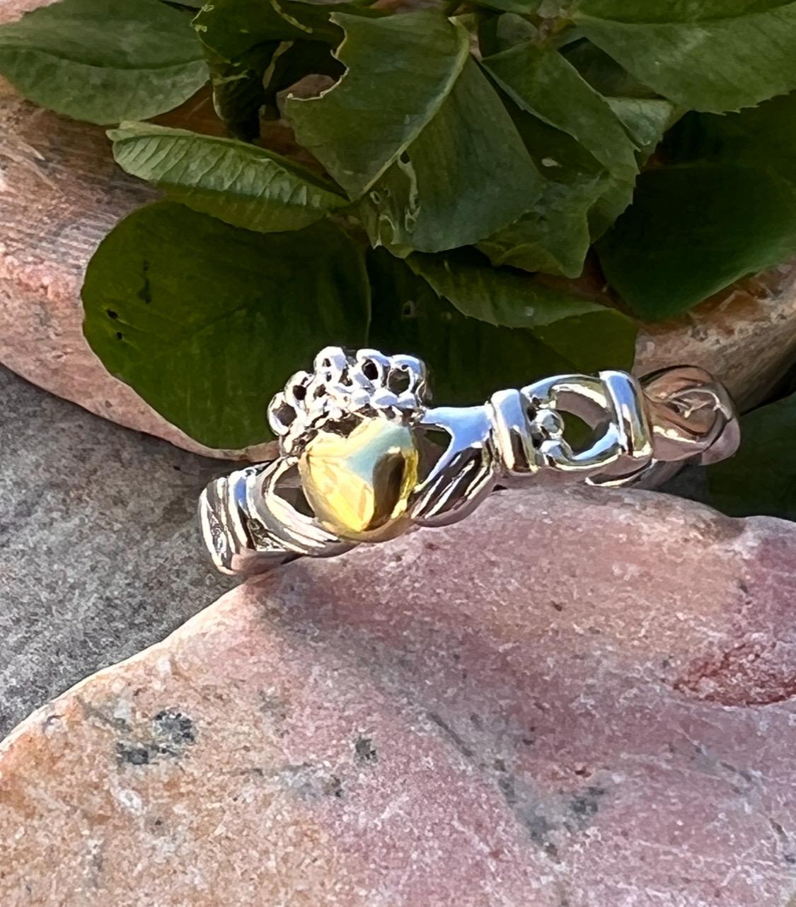 ladies solid claddagh ring with a 14 ct plated heart .