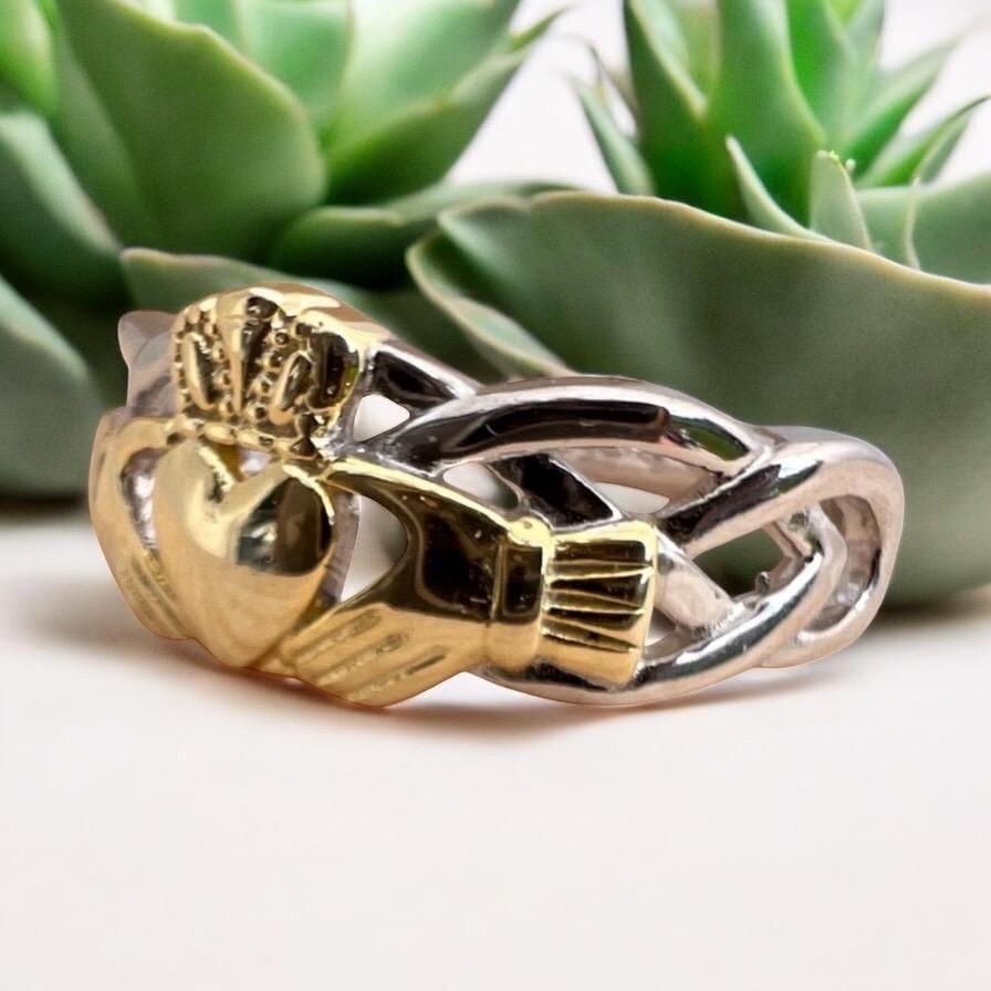 Celtic  woven band with claddagh centre ring  . Come join our Celtic community with this delightful ring .