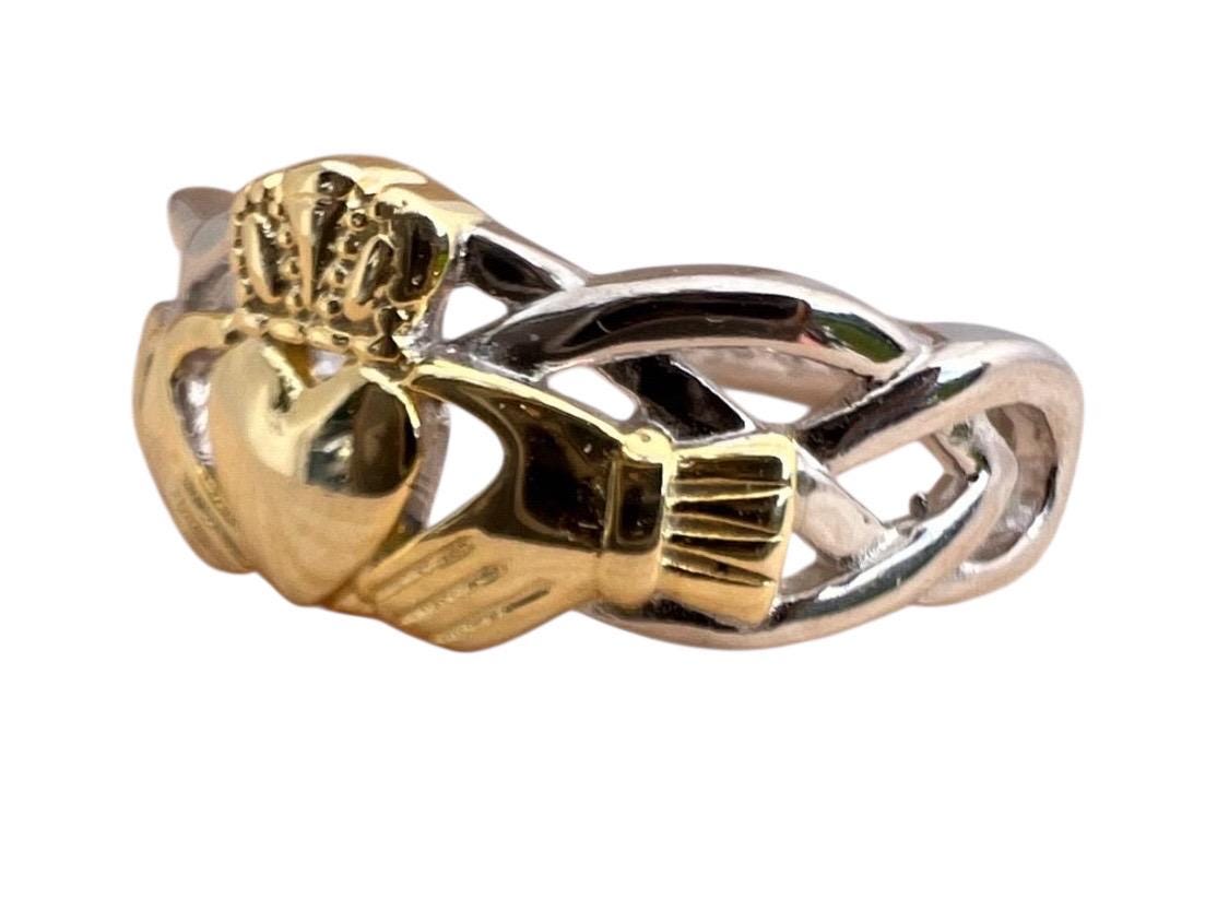 Celtic  woven band with claddagh centre ring  . Come join our Celtic community with this delightful ring .