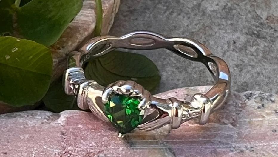 woven band ladies Silver claddagh ring with emerald green cz heart, from Galway the home of the Claddagh ring .